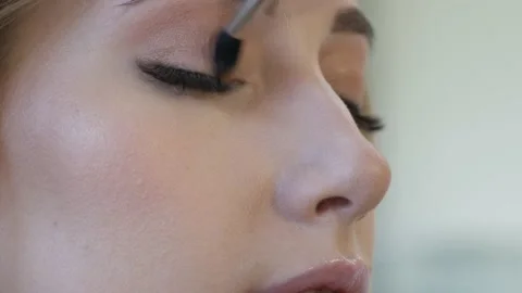 Professional make up artist doing make up for a beautiful caucasian model. Video stock 138937448