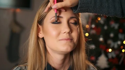 Professional make-up artist makes make-up. Draws eyelines with a brush. In the Stock Footage 118512973