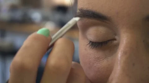 Professional make-up artist making face makeup art. Make up and fashion concept Stock Footage 77679380
