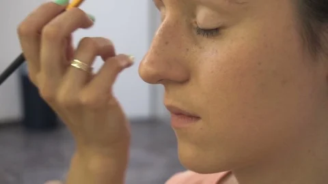 Professional make-up artist making face makeup art. Make up and fashion concept Stock Footage 77680399