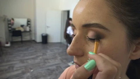 Professional make-up artist making face makeup art. Make up and fashion concept Stock Footage 77682769