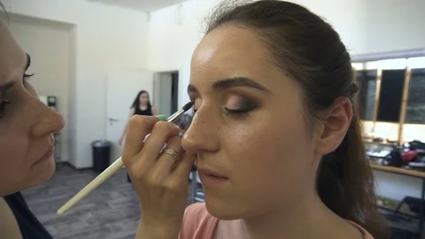 Professional make-up artist making face makeup art. Make up and fashion concept Stock Footage 77684176