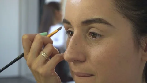 Professional make-up artist making face makeup art. Make up and fashion concept Stock Footage 77750978