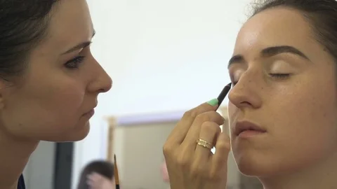 Professional make-up artist making face makeup art. Make up and fashion concept Stock Footage 77752549