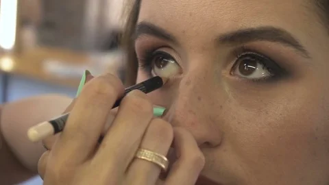 Professional make-up artist making face makeup art. Make up and fashion concept Stock Footage 77762309