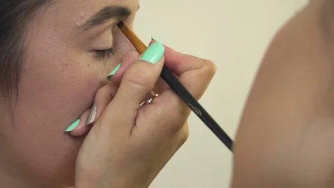 Professional make-up artist making face makeup art. Make up and fashion concept Stock Footage 77820611