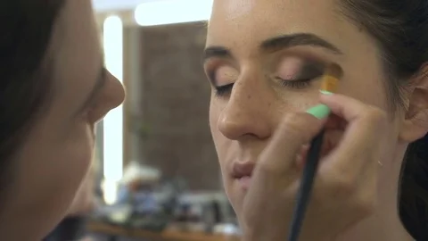 Professional make-up artist making face makeup art. Make up and fashion concept Stock Footage 77821190