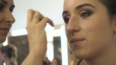 Professional make-up artist making face makeup art. Make up and fashion concept Stock Footage