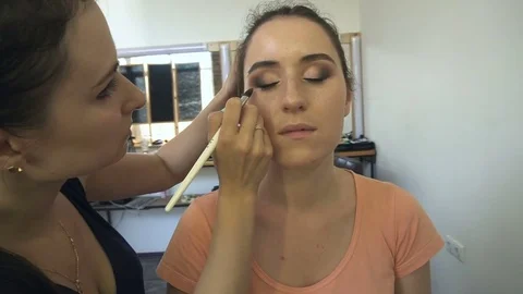 Professional make-up artist making face makeup art. Make up and fashion concept Stock Footage 78075965