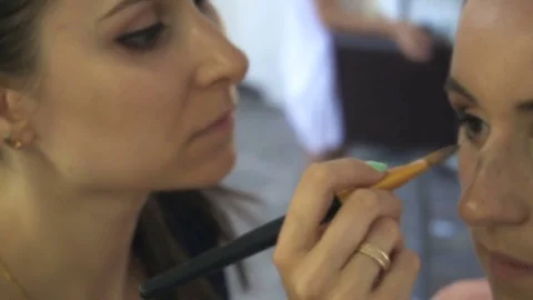 Professional make-up artist making face makeup art. Make up and fashion concept Stock Footage
