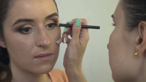 Professional make-up artist making face makeup art. Make up and fashion concept Stock Footage 79006434