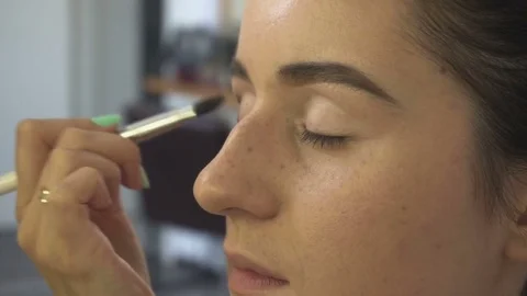 Professional make-up artist making face makeup art. Make up and fashion concept Stock Footage 79052110