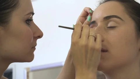 Professional make-up artist making face makeup art. Make up and fashion concept Stock Footage 79052656