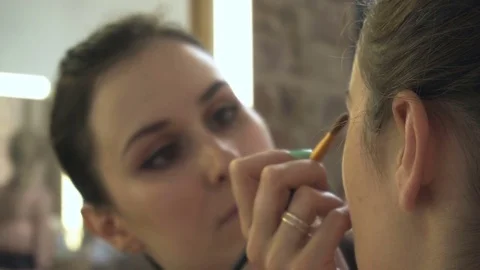 Professional make-up artist making face makeup art. Make up and fashion concept Stock Footage 79054929