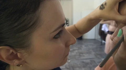 Professional make-up artist making face makeup art. Make up and fashion concept Stock Footage 79055593