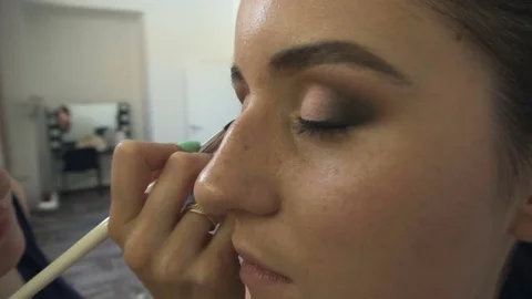Professional make-up artist making face makeup art. Make up and fashion concept Stock Footage 79056778