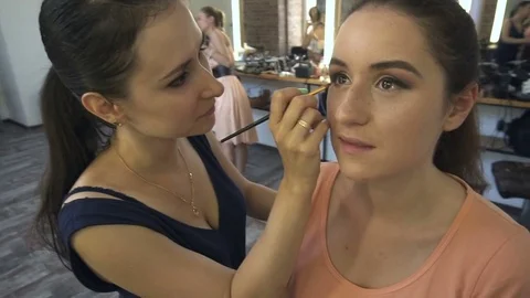 Professional make-up artist making face makeup art. Make up and fashion concept Stock Footage 79058587