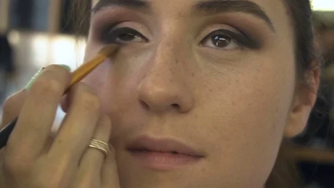 Professional make-up artist making face makeup art. Make up and fashion concept Stock Footage 79059125