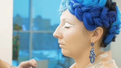 A professional make-up artist prepares a model for a photo shoot. Video stock 85451646