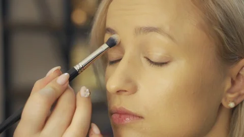 Professional make-up artist at work brush hand closeup - beauty fashion industry Video stock 101020895