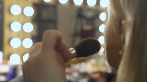 Professional make-up artist at work brush hand closeup - beauty fashion industry Stock Footage 101021705
