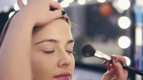 Professional make-up artist at work: closeup view of female hands applying Stock Footage 83165106