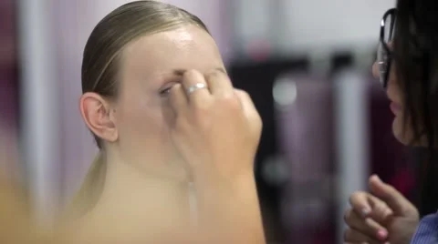 Professional make up artist working with a model Stock Footage 67318445