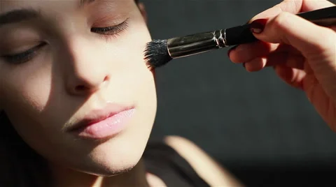 Professional make-up. Close-up of blush being applied on cheekbones Stock Footage 54625797