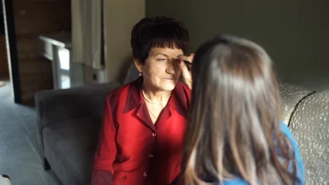 Professional make-up. Makeup artist doing makeup for an elderly woman Stock Footage 106377921