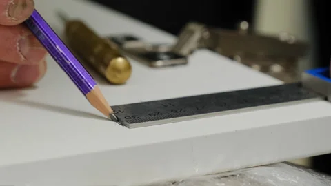 Professional makes marks on surface before assembling furniture Video stock 316186633