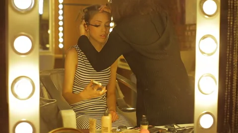 Professional makeup artist apply makeup to an attractive young woman. Stock Footage 49979749