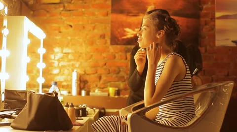 Professional makeup artist apply makeup to an attractive young woman. Stock Footage 50345155
