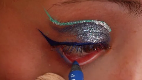 Professional makeup artist applying blue eyeliner Stock Footage 327809192