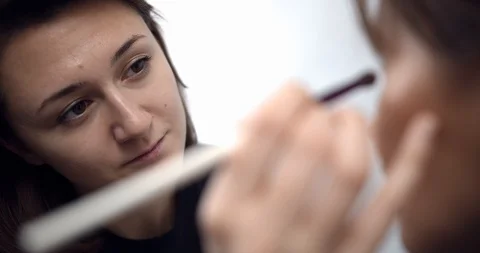 Professional makeup artist applying makeup on models face before fashion show Stock Footage 126354971