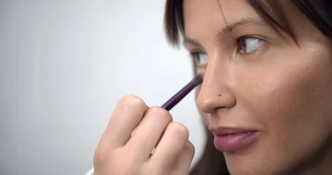 Professional makeup artist applying makeup on models face before fashion show Stock Footage 126355181