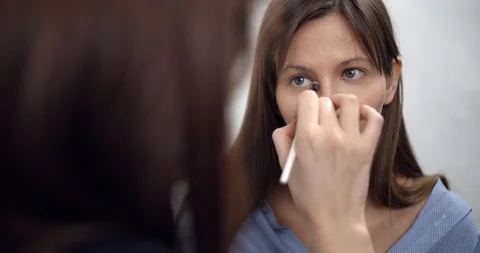 Professional makeup artist applying makeup on models face before fashion show Stock Footage 126355245