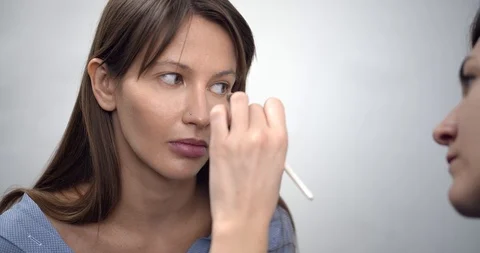 Professional makeup artist applying makeup on models face before fashion show Stock Footage 126355266