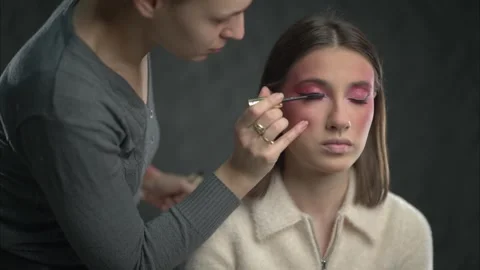 Professional Makeup Artist Applying Mascara to a Young Womans Lashes for Beauty Stock Footage 314337774