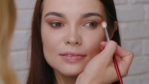 Professional Makeup Artist Applying Nude Eyeshadow With Blending Brush on Model Stock Footage 329053248