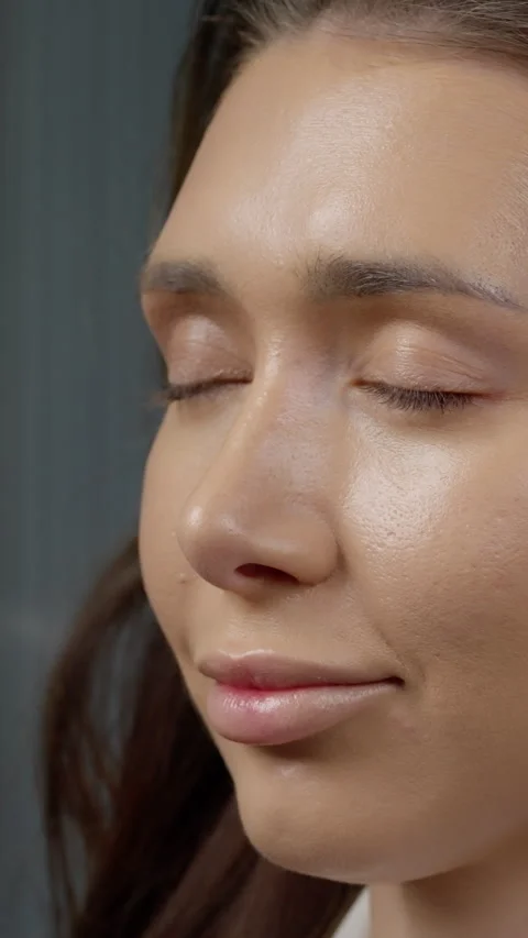 Professional makeup artist applying precise eyeshadow on female models eyelids Stock Footage 304334046