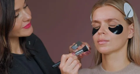 Professional makeup artist does makeup model. Close-up make-up foundation Stock Footage 120148360