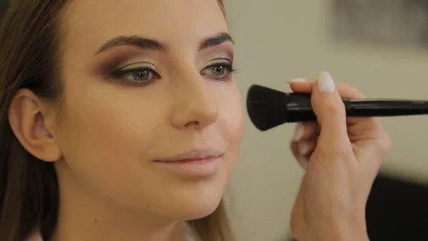 Professional makeup artist does makeup to a client of a beauty salon. Stock-Footage 120654757