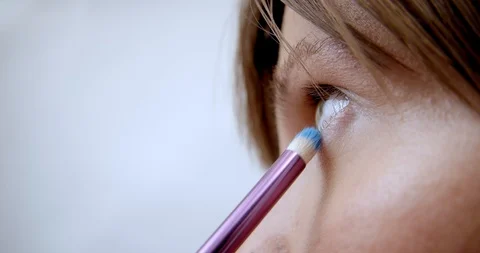 Professional makeup artist does makeup of young model. Close-up view of make-up Stock Footage 126356300