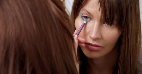 Professional makeup artist does makeup of young model. Close-up view of make-up Stock Footage 126356392