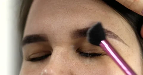 Professional makeup artist doing make up of woman in beauty salon. Stock Footage 307775644