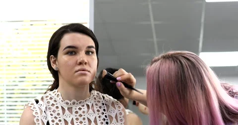 Professional makeup artist doing make up of woman in beauty salon. Stock Footage 307775696