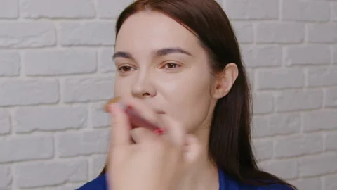 Professional Makeup Artist Using Brushes and Palette to Apply Foundation on Stock-Footage 327789330