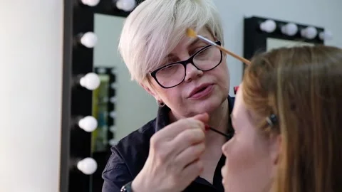 Professional makeup artist working with beautiful young woman 스톡 동영상 109852886