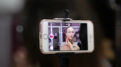 Professional makeup artist working with a model And showing blogging process Stock Footage 67318392