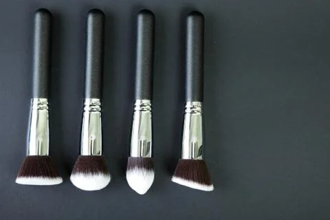 Professional makeup brushes on a black background, natural cloth Stock Photos